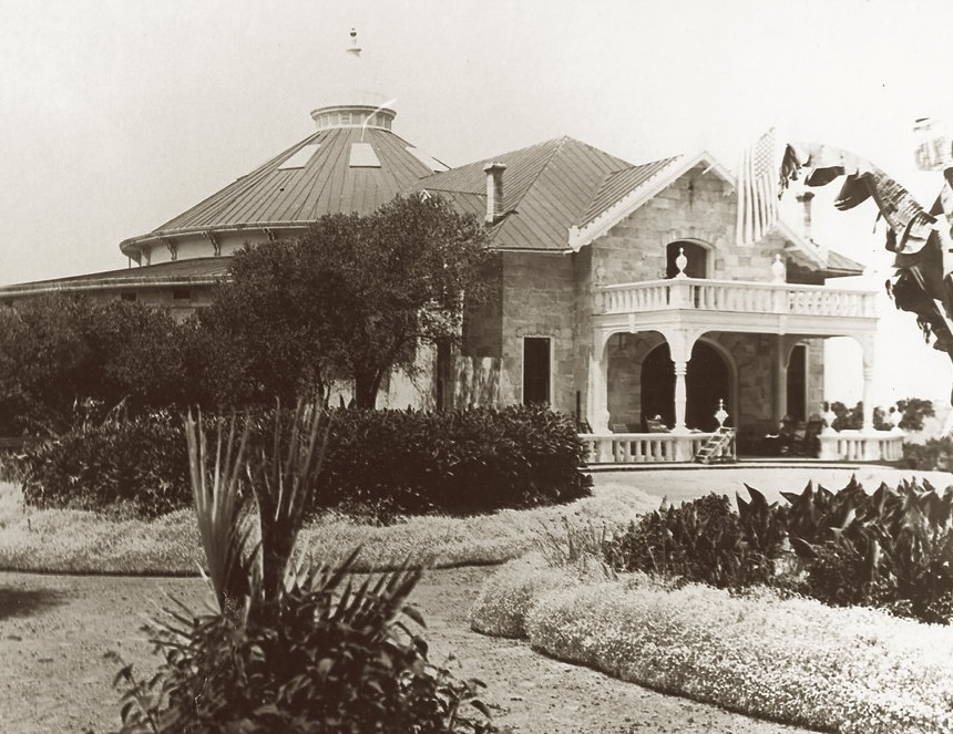 Stone resort building with a domed pavilion and columned veranda, surrounded by gardens, in 19th-century Napa Valley